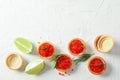 Flat lay composition with tartlets with caviar, rosemary and limes