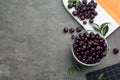 Flat lay composition with tasty acai berries on grey table. Space for text Royalty Free Stock Photo