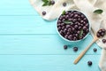 Flat lay composition with tasty acai berries on blue wooden table. Space for text Royalty Free Stock Photo