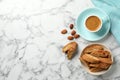 Flat lay composition with tasty cantucci and coffee on white marble table, space for text. Traditional Italian almond Royalty Free Stock Photo