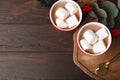 Flat lay composition of tasty cocoa with marshmallows on wooden table Royalty Free Stock Photo