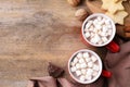 Flat lay composition of tasty cocoa with marshmallows on wooden table Royalty Free Stock Photo