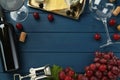 Flat lay composition with tasty red wine and grapes on blue wooden table, space for text Royalty Free Stock Photo