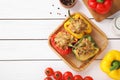 Flat lay composition with tasty stuffed bell peppers on wooden table, top view