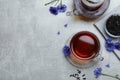 Flat lay composition with tea and cornflowers on light table. Space for text Royalty Free Stock Photo