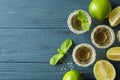 Flat lay composition with tequila shots, salt, lime slices and mint Royalty Free Stock Photo