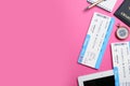 Flat lay composition with tickets on pink background, space for text. Travel agency concept