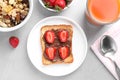 Flat lay composition of toast with chocolate spread and strawberries on grey table. Healthy breakfast Royalty Free Stock Photo