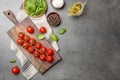 Flat lay composition with fresh tomatoes, oil and basil on grey background Royalty Free Stock Photo