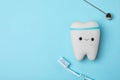 Flat lay composition with tooth, brush and mirror on color background. Professional dentist