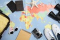 Flat lay composition with tourist items on world map