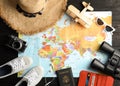 Flat lay composition with tourist items and world map. Travel agency