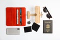 Flat lay composition with toy airplane and passport on white. Travel agency