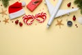 Flat lay composition with toy airplane, Santa hat and space for text on yellow background. Christmas vacation