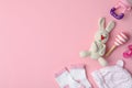 Flat lay composition with toy bunny and child`s clothes on background, space for text Royalty Free Stock Photo