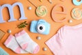 Flat lay composition with toy camera on orange. Future photographer Royalty Free Stock Photo