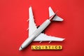 Flat lay composition with toy plane and word LOGISTICS on red background. Wholesale concept Royalty Free Stock Photo