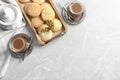 Flat lay composition with tray of cookies for Islamic holidays, cups and space for text on table. Royalty Free Stock Photo