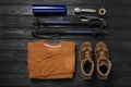 Flat lay composition with trekking poles and other hiking equipment on black wooden background Royalty Free Stock Photo