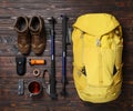 Flat lay composition with trekking poles and other hiking equipment on wooden background Royalty Free Stock Photo