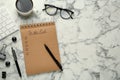 Flat lay composition with unfilled To Do list and cup of coffee on white marble table, space for text Royalty Free Stock Photo