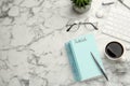 Flat lay composition with unfilled To Do list and cup of coffee on white marble table, space for text Royalty Free Stock Photo