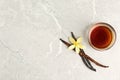 Flat lay composition with vanilla extract on light marble table. Space for text Royalty Free Stock Photo