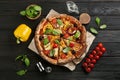 Flat lay composition with vegetable pizza on wooden table Royalty Free Stock Photo