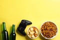 Flat lay composition with video game controller, snacks and space for text