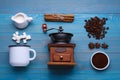 Flat lay composition with vintage manual coffee grinder and spices on light blue wooden background Royalty Free Stock Photo