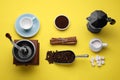 Flat lay composition with vintage manual grinder and geyser coffee maker on yellow background Royalty Free Stock Photo