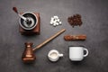 Flat lay composition with vintage manual grinder and turkish coffee pot on black table Royalty Free Stock Photo