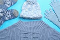 Flat lay composition with warm clothes on blue background Royalty Free Stock Photo