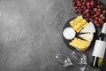 Flat lay composition with wine, snacks on grey background