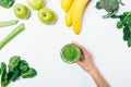 Flat lay composition woman's hand holding glass of green smoothie Royalty Free Stock Photo