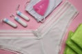 Flat lay composition with woman`s panties and menstrual hygiene products on pink background