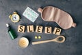 Flat lay composition with word Sleep made of wooden cubes and insomnia remedies on grey background Royalty Free Stock Photo