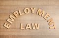 Flat lay composition with phrase EMPLOYMENT LAW on wooden background Royalty Free Stock Photo
