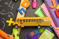 Flat lay composition with yellow school bus model on black background. Transport for students Royalty Free Stock Photo