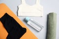 Flat lay composition with yoga equipment on grey background