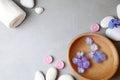 Flat lay composition with zen stones, spa bowl and towel on grey background Royalty Free Stock Photo