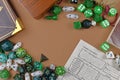 Flat lay concept design for tabletop role playing with colorful green and white RPG dices, character sheet and rule books