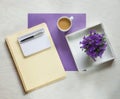 Flat lay concept with writing pad, pen and beautiful violet flowers Royalty Free Stock Photo