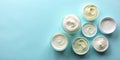 Flat Lay of Cream Samples on Light Blue Background Royalty Free Stock Photo