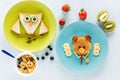 Flat lay with creatively styled children`s breakfast with berries and kiwi