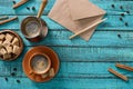 flat lay with cup of coffee bowl with brown sugar envelope roasted coffee beans and cinnamon sticks around on blue Royalty Free Stock Photo