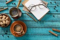 flat lay with cup of coffee, eyeglasses, bowl with brown sugar, empty notebook, roasted coffee beans and cinnamon sticks around Royalty Free Stock Photo