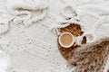 Flat lay cup of coffee, plaid blanket on rattan straw. Morning breakfast.