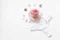 Flat lay a cup of tea with a string of pearls near flower petals and women`s thong on a white background. Place for text. Minimal Royalty Free Stock Photo