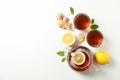 Flat lay. Cups with tea and teapot, lemon, mint and ginger